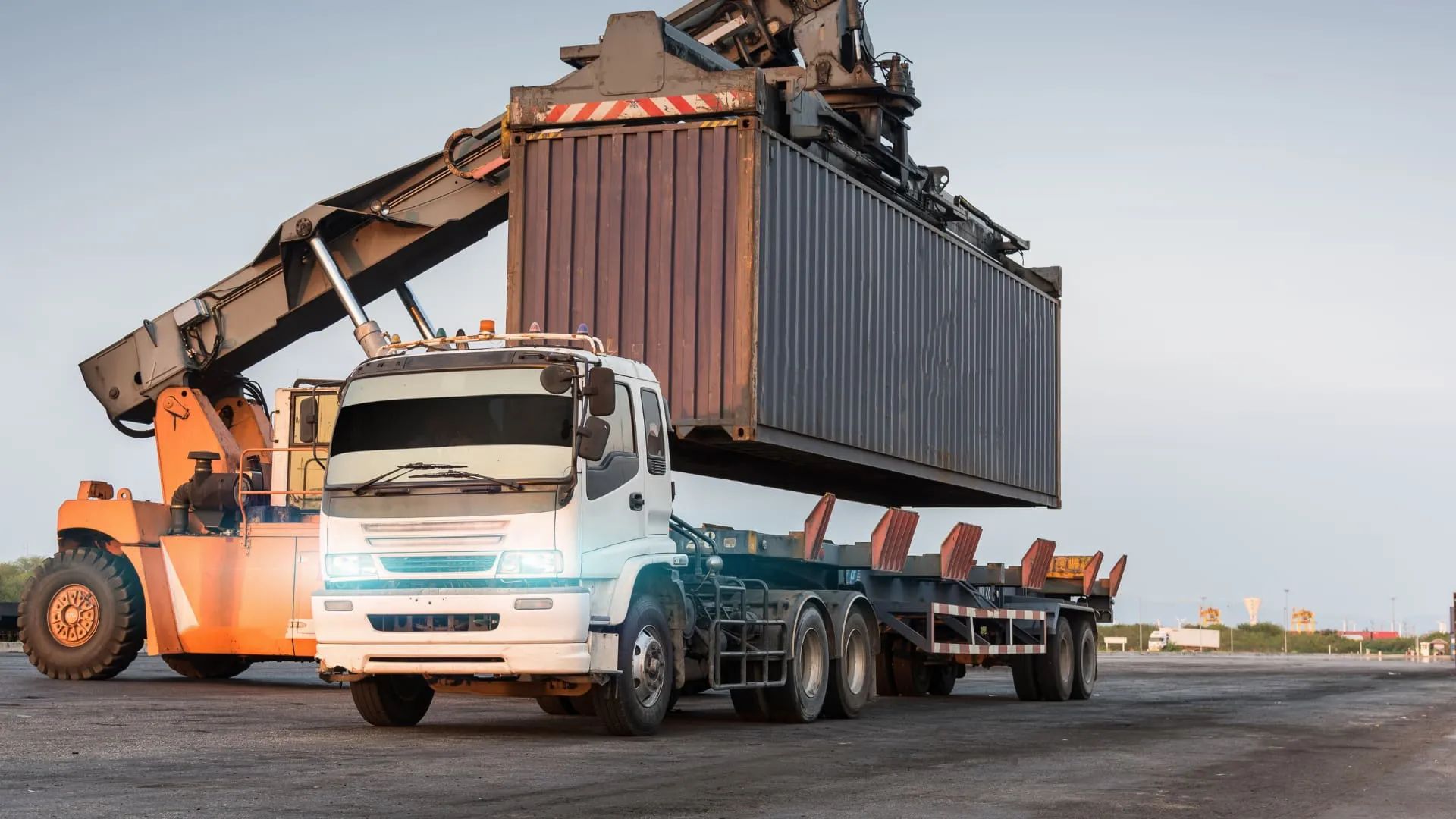 Shipping container being lowered onto a flatbed truck